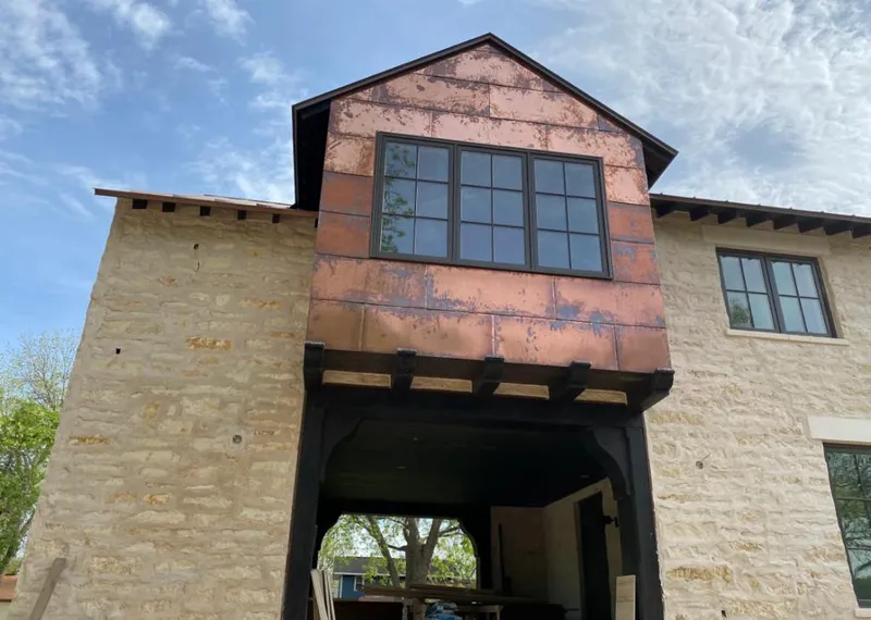 Copper metal panel facade on a stone building for Skylight Installation in Smyrna